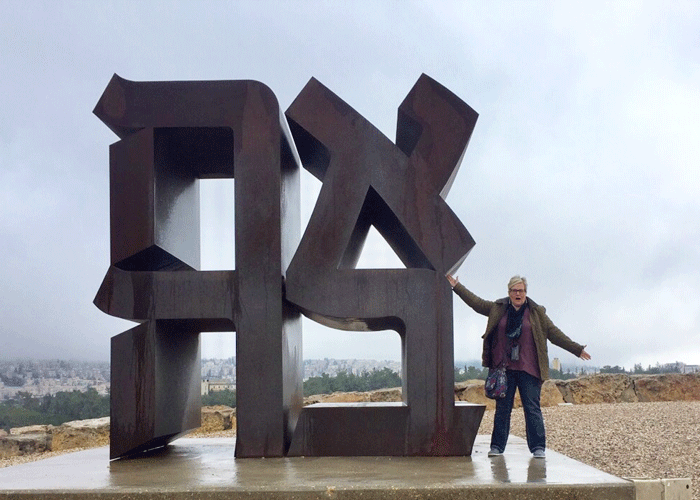 Jodi Phares next to Robert Indiana's Love Sculpture at the Israel Museum.